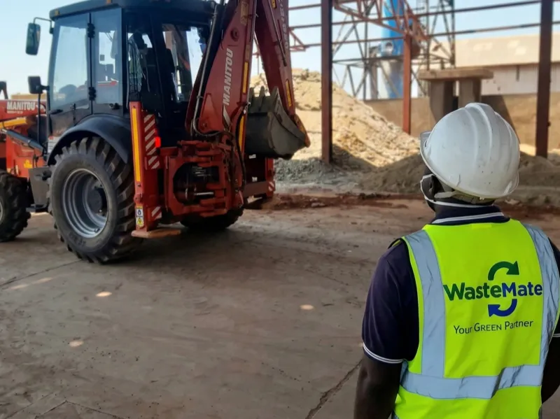 WasteMate supervisor overlooking Manitou loader at industrial site