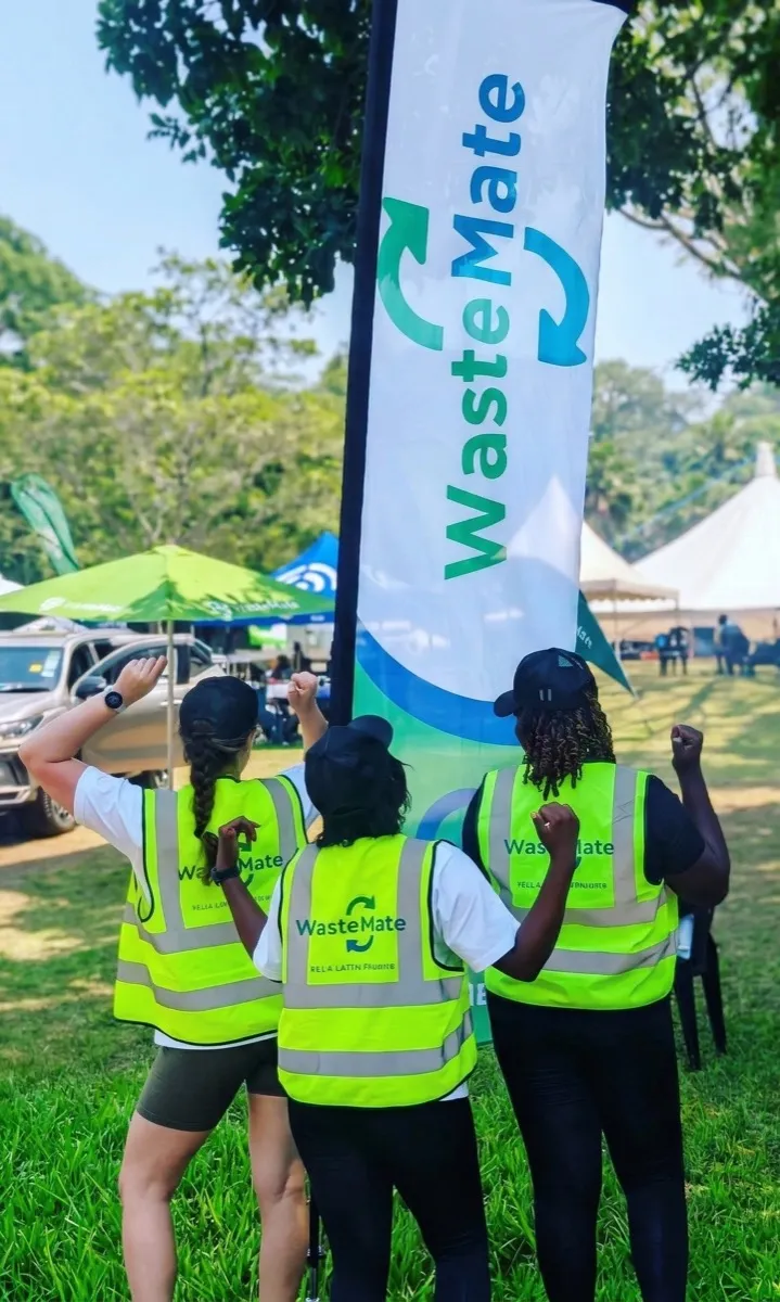 WasteMate team at outdoor event with branded banner